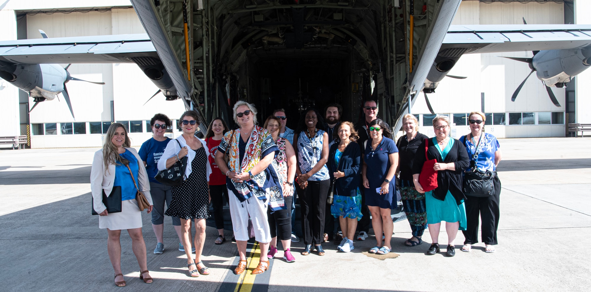 Educators from Department of Defense Education Activity Europe and others pose for a photo in front of a C-130J Hercules Aircraft during an immersion tour at Ramstein Air Base, Germany, Aug. 9 2024. As well as touring the 86th Airlift Wing’s aircraft, members of the immersion took a window tour by bus, where they saw the different entities of the Ramstein AB mission and how they contribute to operation around the globe. (U.S. Air Force photo by Senior Airman Thomas Karol)
