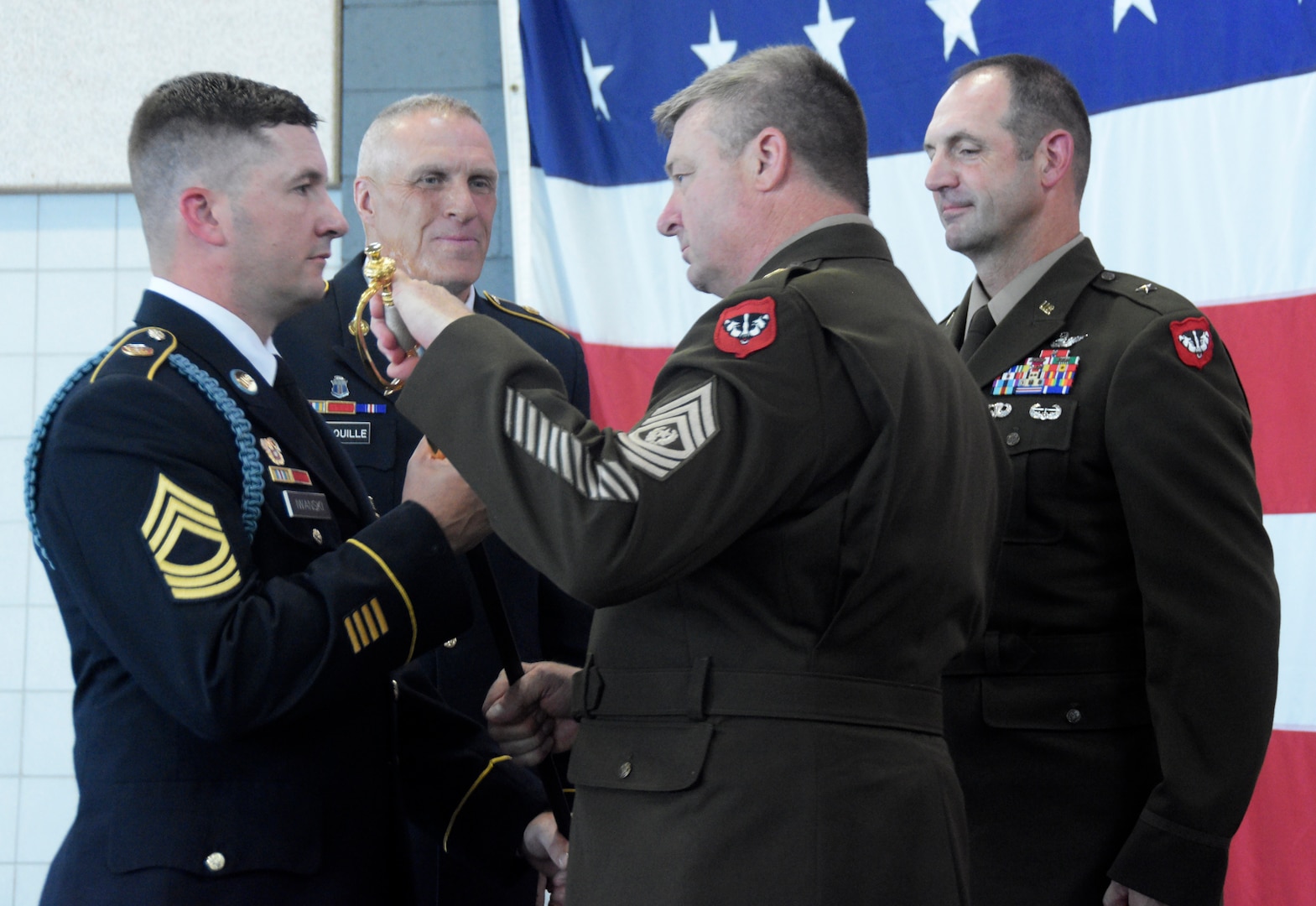 Incoming state command sergeant major Command Sgt. Maj. Duane Weyer returns an Army saber, representing a noncommissioned officer’s responsibility, to the sword bearer during a formal change of responsibility ceremony Aug. 10 at Joint Force Headquarters in Madison, Wis. Weyer follows Command Sgt. Maj. Curtis Patrouille as state command sergeant major for the Wisconsin Army National Guard. Combined, Patrouille and Weyer have more than seven decades of military service between them. Wisconsin Department of Military Affairs photo by Vaughn R. Larson