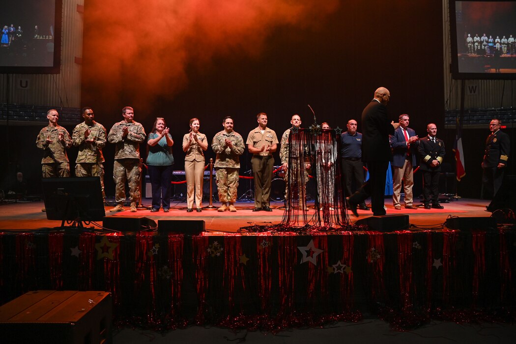 Dr. Christopher Moran, San Angelo Independent School District superintendent, brings joint service leaders from Goodfellow Air Force Base on stage during the 2024 San Angelo Independent School District Convocation at the Foster Communication Coliseum, San Angelo, Texas, Aug. 6, 2024. SAISD schools provided a choir, marching band, mariachis, and orchestra for the event. (U.S. Air Force photo by Airman 1st Class Evelyn J. D’Errico)