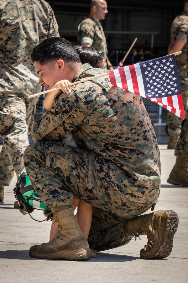 A U.S. Marine with Marine Medium Tiltrotor Squadron (VMM) 165 (Reinforced), 15th Marine Expeditionary Unit, embraces his daughter during a homecoming at Marine Corps Air Station Miramar, California, Aug. 9, 2024. Elements of the 15th MEU, embarked aboard the amphibious transport dock ship USS Somerset (LPD 25), returned home after a seven-month deployment to the Indo-Pacific region in support of regional stability and a free and open Indo-Pacific. (U.S. Marine Corps photo by Lance Cpl. Alexis Ibarra)