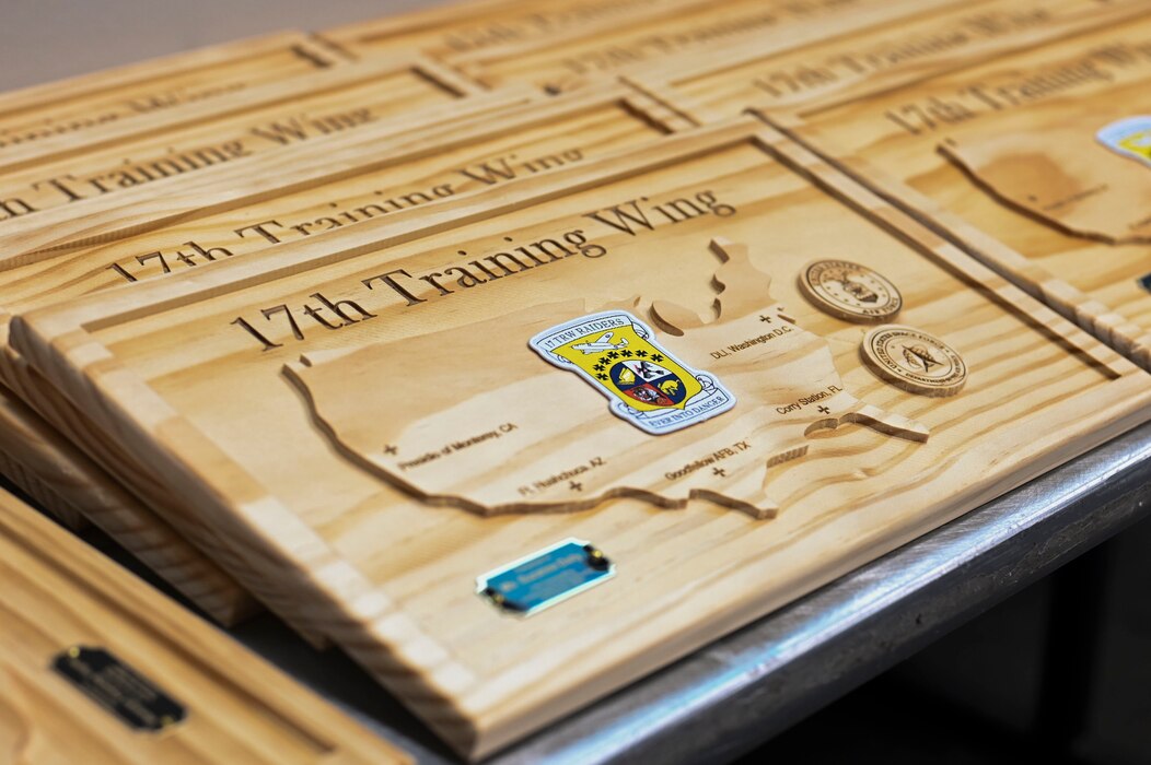 Plaques lay on display during the 17th Training Wing 2nd Quarterly Awards Ceremony at the Powell Event Center, Goodfellow Air Force Base, Texas, Aug. 9, 2024. Quarterly awards were awarded to Airmen and civilians in 12 categories to recognize the recipients' exceptional work. (U.S. Air Force photo by Airman 1st Class Madi Collier)