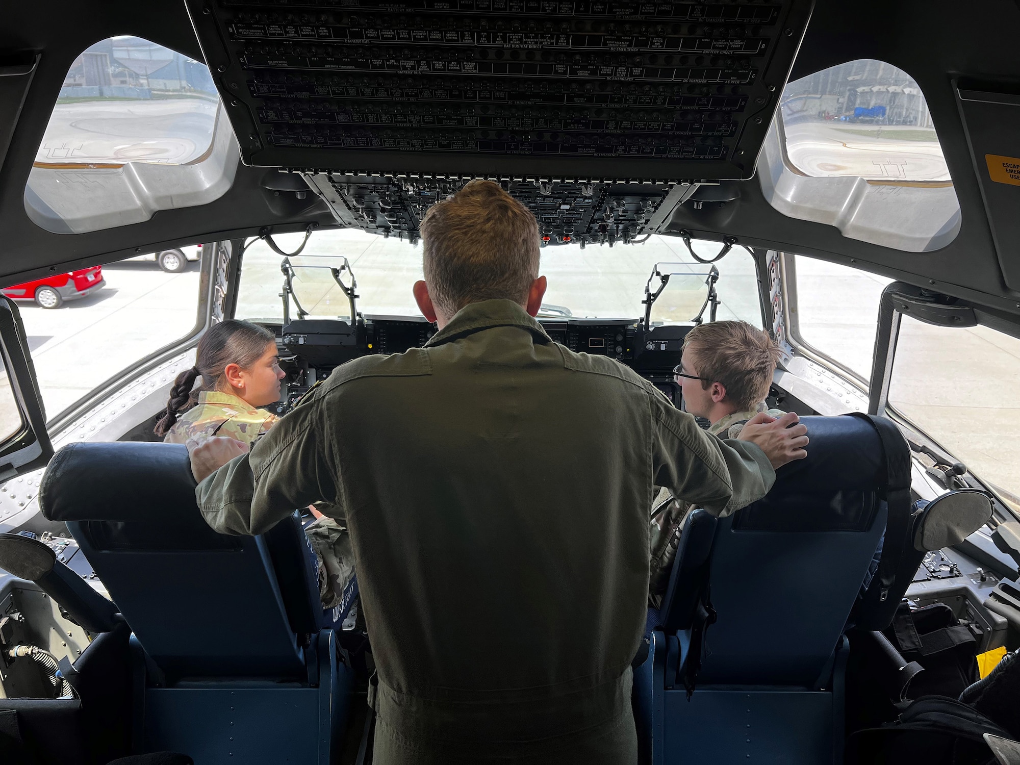 First Lt. Jake Kester, 89th Airlift Squadron pilot, (middle) talks about the flight deck of a C-17 Globemaster III to Air Force Academy cadets during their visit on July 26, 2024. The cadets visited both the 655th ISR Wing and the 445th Airlift Wing while visiting Wright-Patterson Air Force Base. The cadets visited both the 655th ISR Wing and the 445th Airlift Wing to learn about the various jobs available and what work days would look like. (U.S. Air Force Photo by Capt. Rachel Goodspeed)
