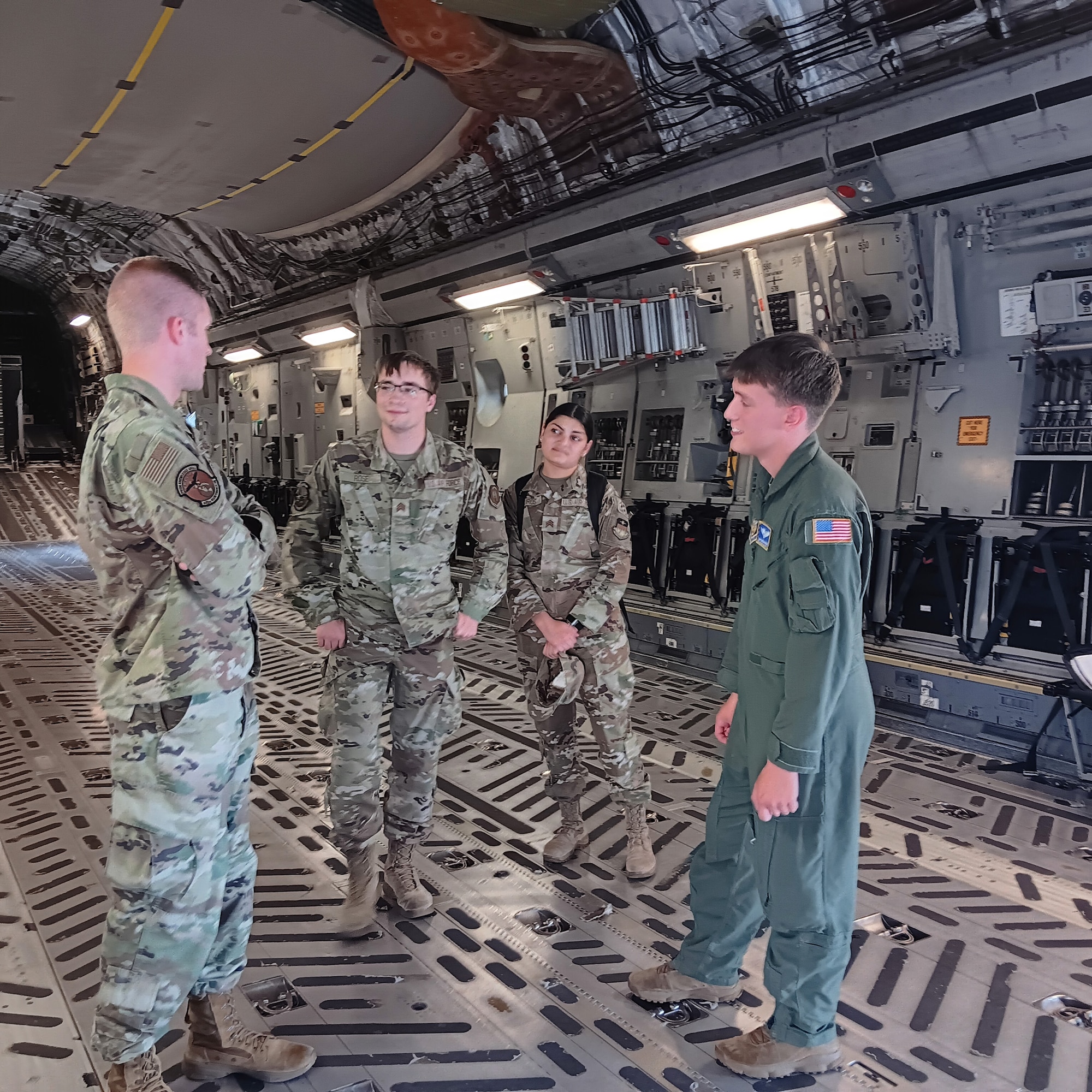 Capt. Eric Dolan, 445th Maintenance Squadron director of operations, (left) shares his experiences about being a maintenance officer in the Air Force Reserve to five Air Force Academy cadets during their tour of a 445th Airlift Wing C-17 Globemaster III July 26, 2024. Earlier during the visit, Senior Airman Diegan Rhodes (right), 89th Airlift Squadron loadmaster, explained his role as a loadmaster and the various missions he’s been a part of. (U.S. Air Force Photo by Stacy Vaughn)