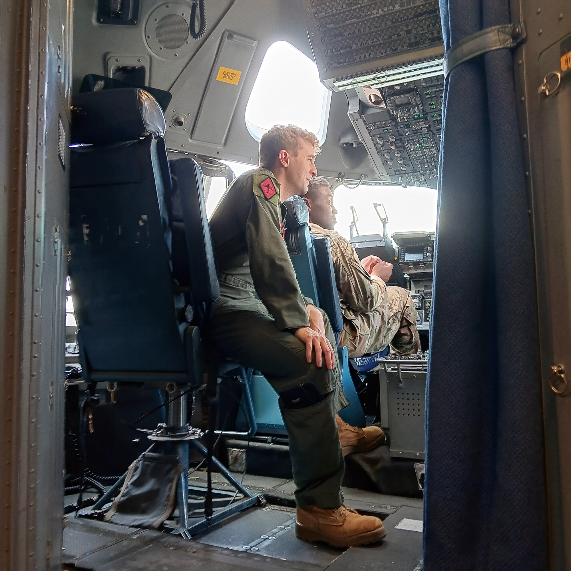 First Lt. Jake Kester, 89th Airlift Squadron pilot, talks about the flight deck of a C-17 Globemaster III to an Air Force Academy cadet July 26, 2024. Five Air Force Academy cadets visited the 445th Airlift Wing and toured the C-17, asking questions about the mechanics of the C-17 and serving in the Air Force Reserve.