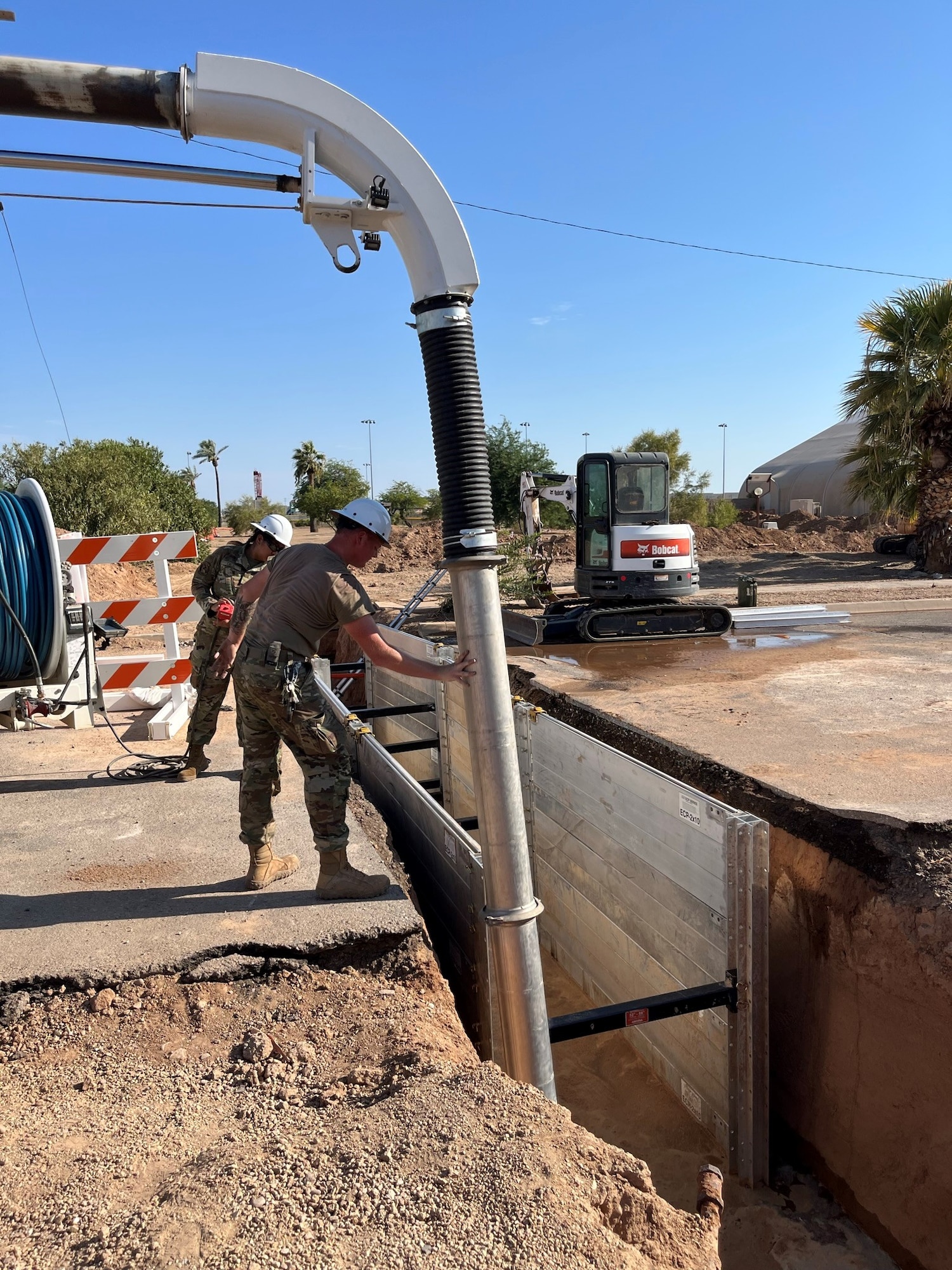U.S. Air Force Airmen assigned to the 56th Civil Engineer Squadron pump water through a new pipe system during a renovation of the base gym and chapel heating, ventilation, and air conditioning systems, at Luke Air Force Base, Arizona.
