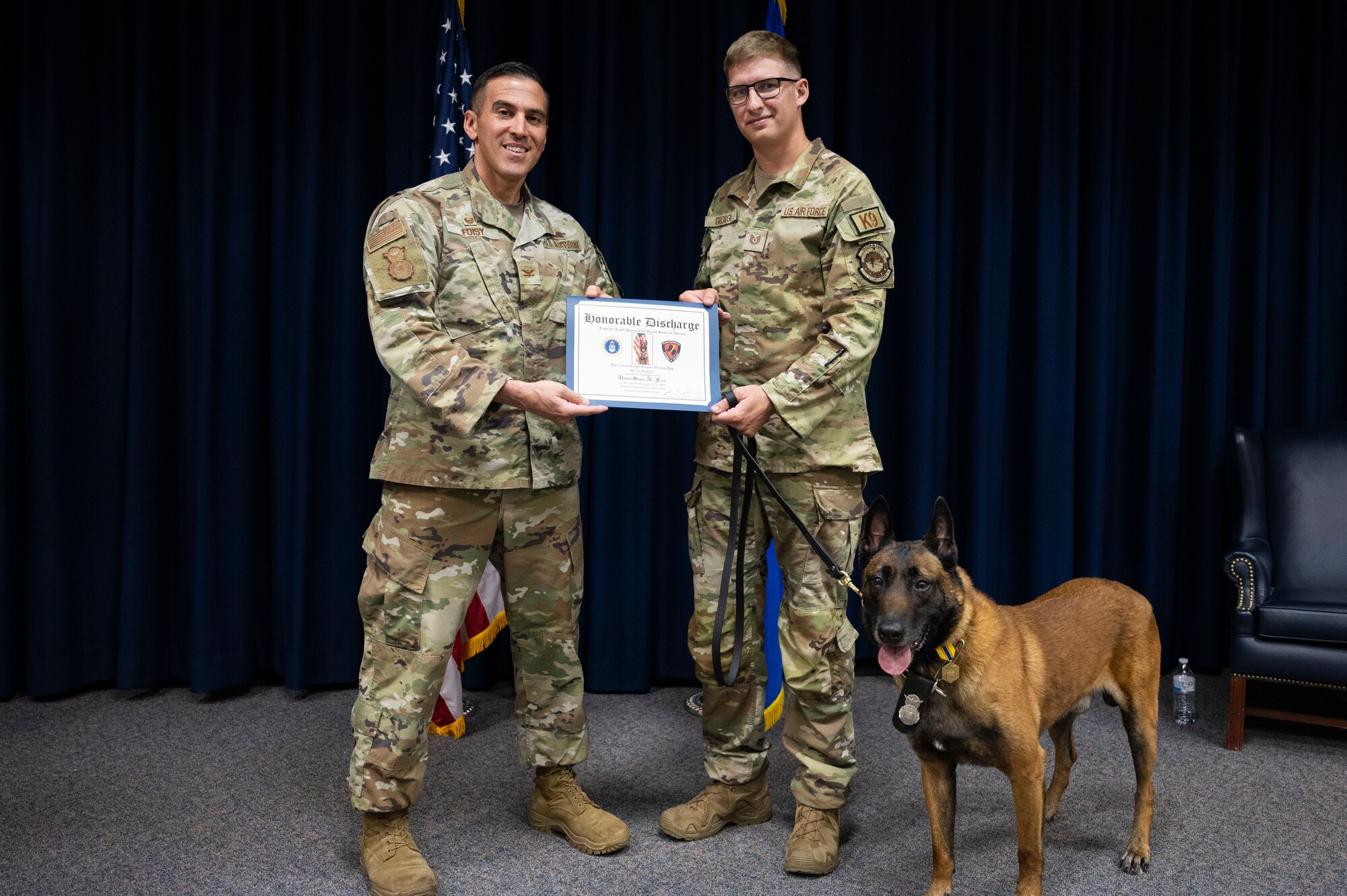 A dog and men pose.