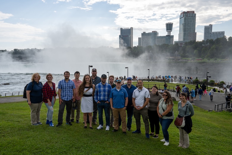 Group photo of people standing in front of Niagara Falls