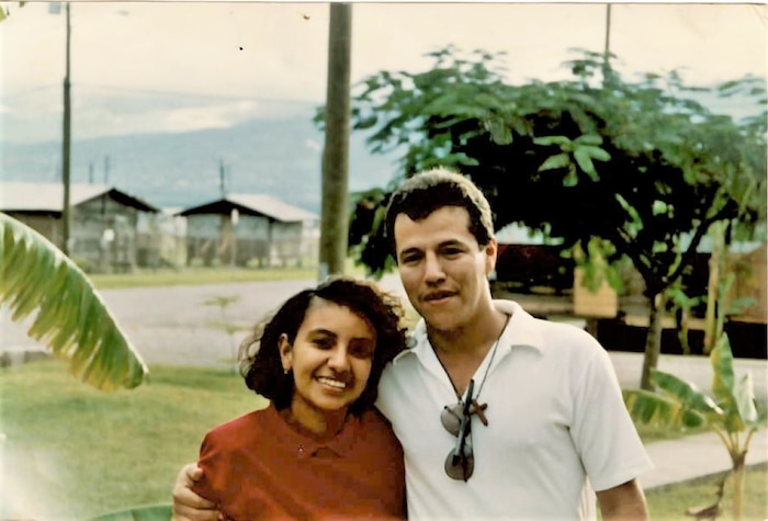A photo of two people posing for a picture.