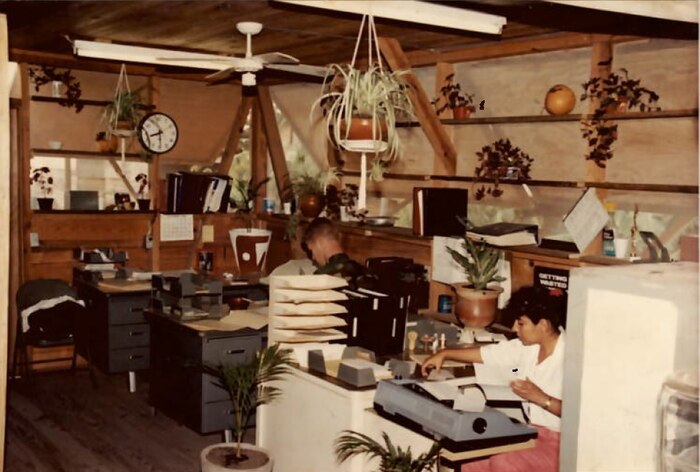 A photo of a person working at a desk.