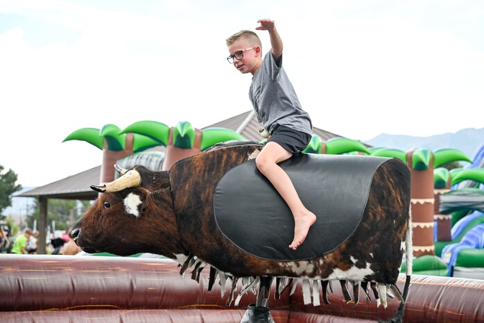 A child rides a mechanical bull ride