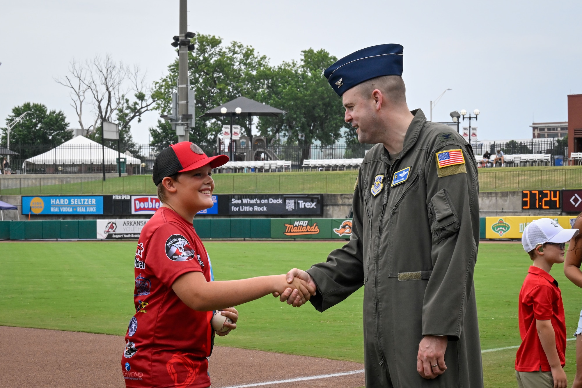 Col. Davies shakes a child's hand.