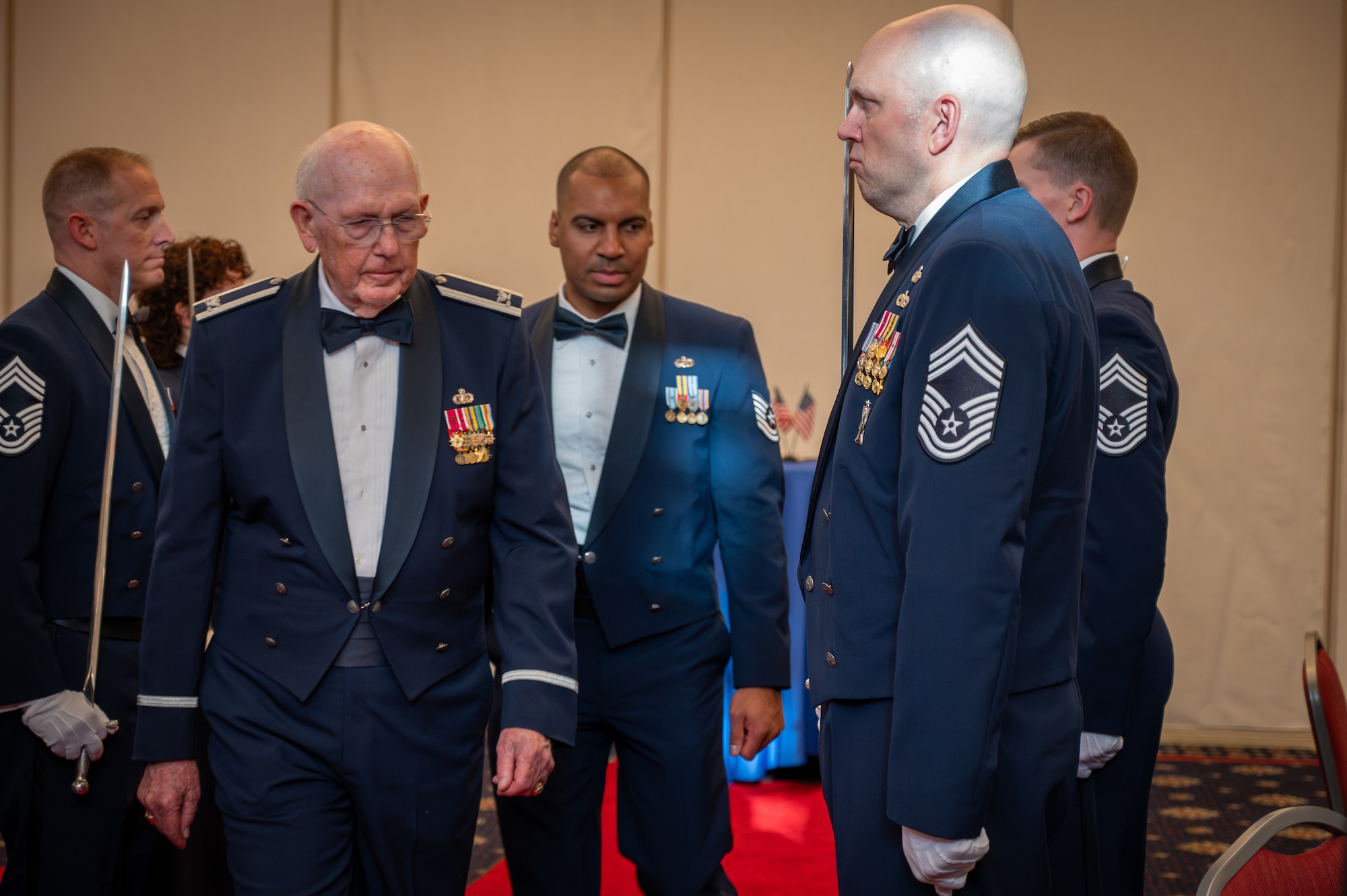 Ret. Col. Richard F. Law, a pivotal figure in OSI’s history, takes his seat at the Order of the Sword ceremony, July 31, 2024, at Quantico Marine Corps Base, Virginia. Law’s contributions to OSI have left a legacy, culminating in his induction into the Order of the Sword in 1991 and the OSI Hall of Fame in 1999.