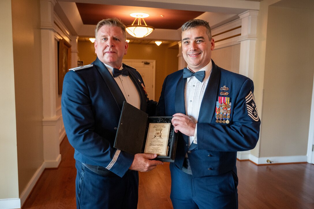 Before the OSI Order of the Sword ceremony, July 31, 2024, at Quantico Marine Corps Base, Virginia, Ret. Brig. Gen. Terry L. Bullard and Chief Master Sgt. Gregg Gow, who both served as OSI's top leaders, stand together. Bullard, who retired in 2023, relinquished command to Brig. Gen. Amy Bumgarner last year.