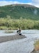 Chief Warrant Officer 3 Nick Lime, an aviation maintenance technician and crew chief assigned to Delta Company, 2-211th General Support Aviation Battalion, inspects and removes the missing rafter’s pack raft from the Goodnews River, Aug. 12, 2024. Alaska Army National Guard aviators with Alpha Company, 1-168th General Support Aviation Battalion, operating a UH-60L Black Hawk helicopter out of Bethel, Alaska, helped rescue an overdue rafter in the vicinity of Goodnews Lake.