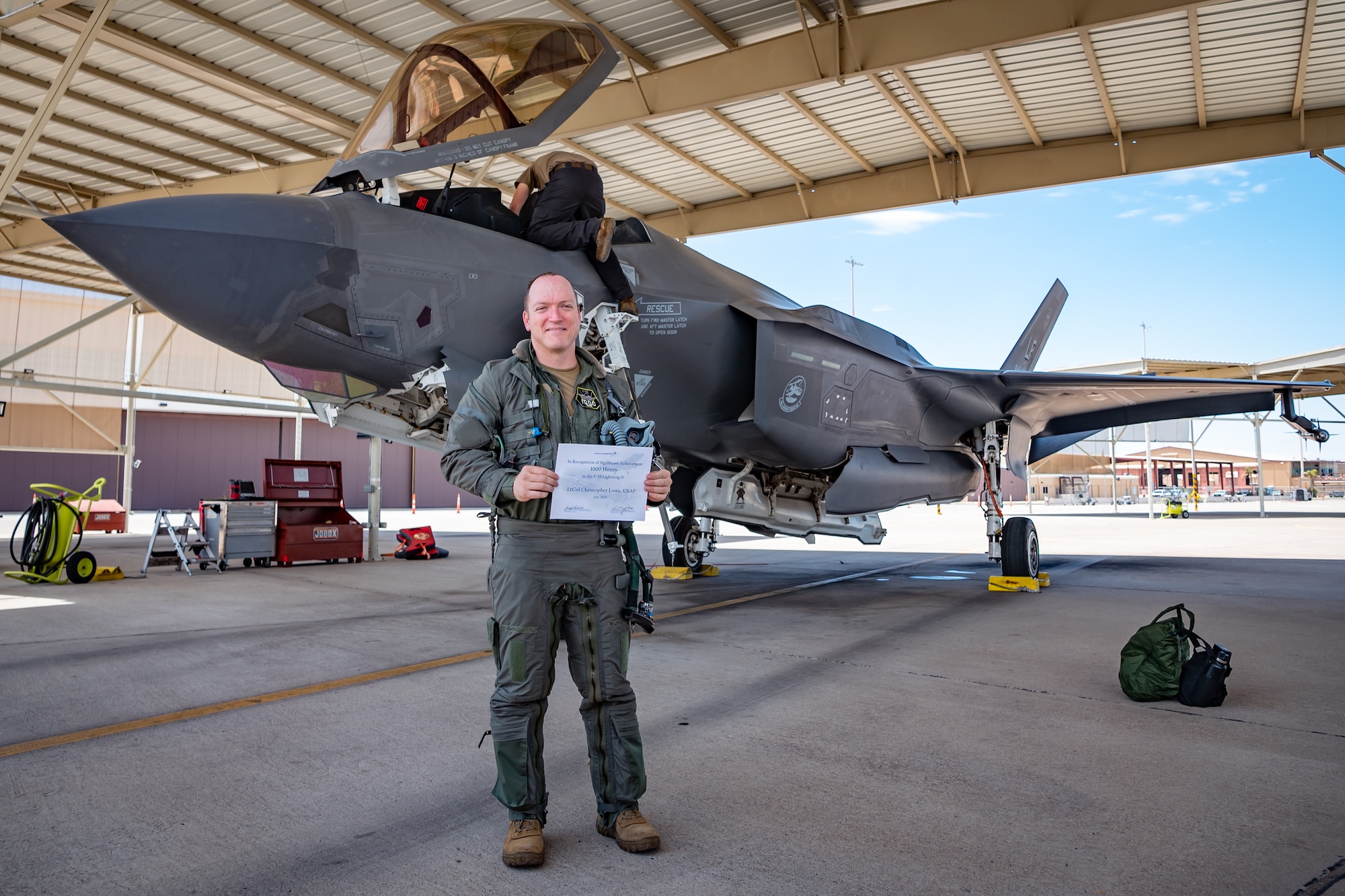 Reserve Citizen Airman Lt. Col. Christopher "Lube" Lowe, F-35 instructor pilot, stands proudly in front of his F-35 Lightning II after completing his 1,000th flight hour in the aircraft at Luke Air Force Base, Ariz., Aug. 9, 2024. Lowe's milestone is a rare achievement within the 944th Fighter Wing, showcasing his commitment and the crucial support from his fellow Airmen. (U.S. Air Force photo by Tech. Sgt. Tyler J. Bolken)