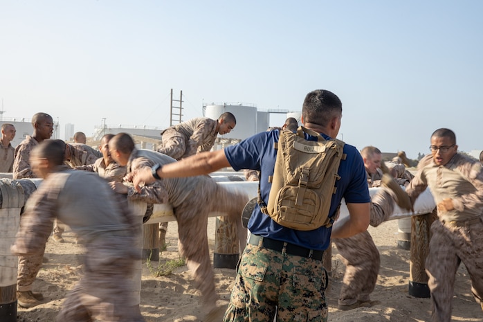 U.S Marine Corps Staff Sgt. Aaron Ruiz, a drill instructor with Lima Company, 3rd Recruit Training Battalion, instructs recruits through an obstacle course after the 2k introduction hike at Marine Corps Recruit Depot San Diego, California, July 25, 2024. During training, recruits conduct a series of progressively longer hikes to physically and mentally condition them to create combat readiness for any necessary future operations as the world's force in readiness. (U.S. Marine Corps photo by Cpl. Sarah M. Grawcock)