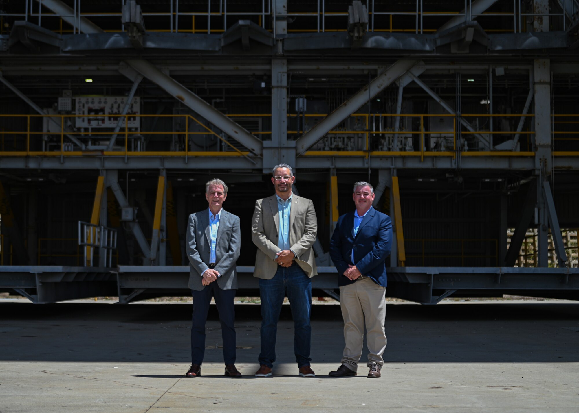 Three people pose a group photo.