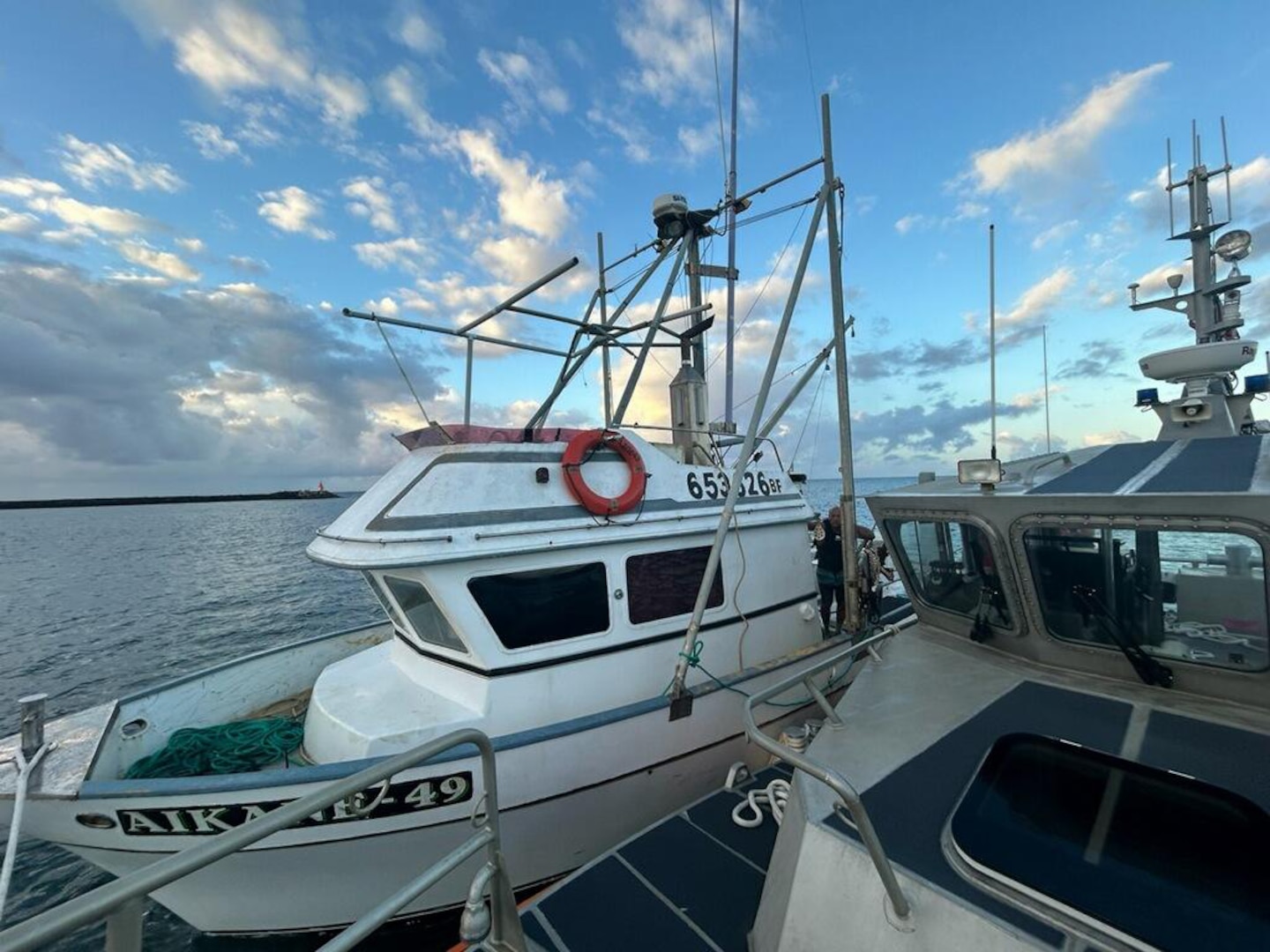 A Coast Guard Station Kauai 45-foot Response Boat-Medium crew tows the 35-foot recreational fishing vessel Aikane-49 off the coast of Kauai Aug. 13, 2024. Station Kauai responded to a phone call from the wife of the vessel’s owner stating the boat was disabled, adrift and taking on water off Pakala Beach. (U.S. Coast Guard photo, courtesy Station Kauai)