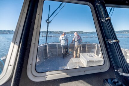 Ty Heslop, dive boat maintenance supervisor, Code 760, Regional Dive Division, at Puget Sound Naval Shipyard & Intermediate Maintenance Facility in Bremerton, Washington, talks with Michael Richardson, diving operations supervisor, Code 760, Regional Dive Division, while enroute to the Port Orchard, Washington, Marina, Aug. 1, 2024. (U.S. Navy photo by Jeb Fach)