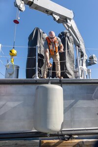 Michael Richardson, diving operations supervisor, Code 760, Regional Dive Division at Puget Sound Naval Shipyard & Intermediate Maintenance Facility in Bremerton, Washington, works under the new dive boat's marine knuckle boom crane enroute to the Port Orchard, Washington, Marina, Aug. 1, 2024. (U.S Navy photo by Wendy Hallmark)