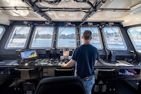 Tyler George, production general foreman, Code 760, Regional Dive Division at Puget Sound Naval Shipyard & Intermediate Maintenance Facility in Bremerton, Washington, pilots the dive locker's new purpose-built dive boat out of the Controlled Industrial Area enroute to the Port Orchard, Washington, Marina, Aug. 1, 2024. (U.S. Navy photo by Jeb Fach)