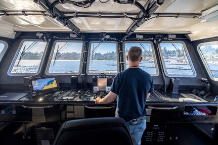 Tyler George, production general foreman, Code 760, Regional Dive Division at Puget Sound Naval Shipyard & Intermediate Maintenance Facility in Bremerton, Washington, pilots the dive locker's new purpose-built dive boat out of the Controlled Industrial Area enroute to the Port Orchard, Washington, Marina, Aug. 1, 2024. (U.S. Navy photo by Jeb Fach)