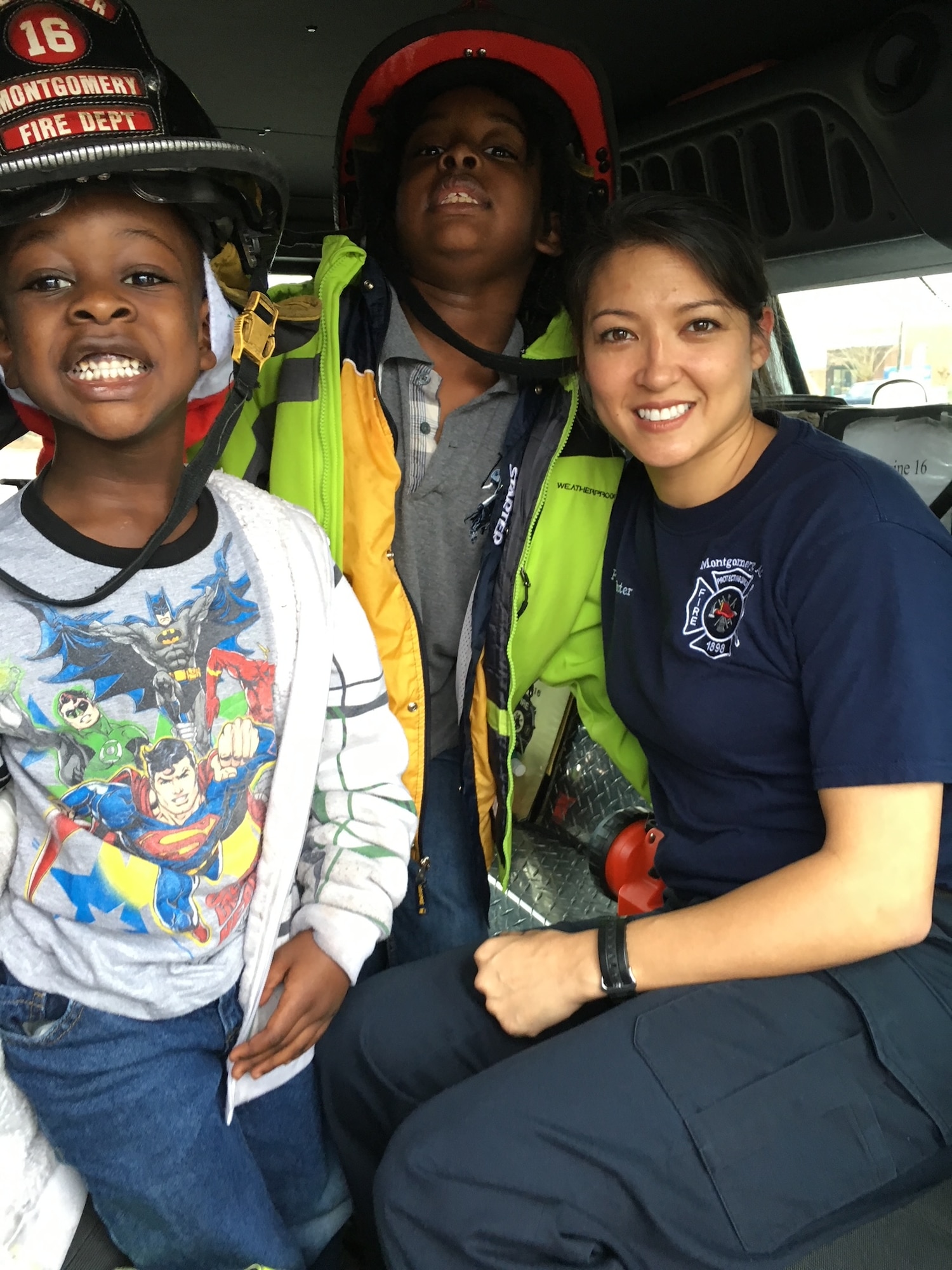 MSgt Cynthia Webster poses with children at an outreach event hosted by the Montgomery, Ala. fire department.