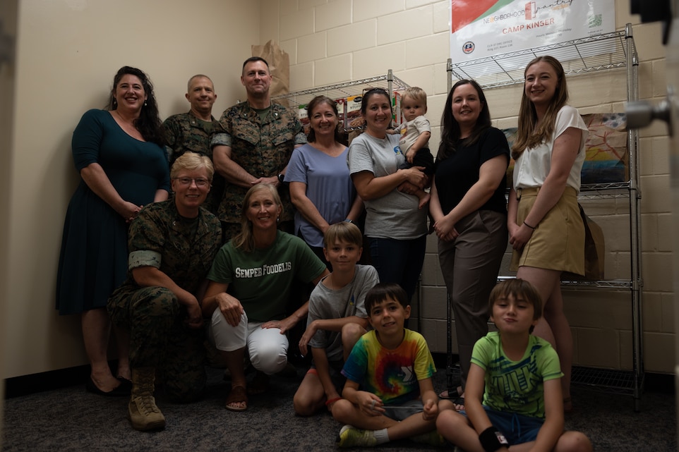 Leadership from Marine Corps Installations Pacific and Combat Logistics Regiment 37, along with members of the Neighborhood Pantry at Camp Butler, pose for a photo during the opening of the new pantry location on Camp Kinser, Okinawa, Japan, July 19, 2024. The Neighborhood Pantry offers food and resources to all service members across the island, in addition to its existing location on Camp Foster. (U.S. Marine Corps photo by Cpl. Jesse Davis)