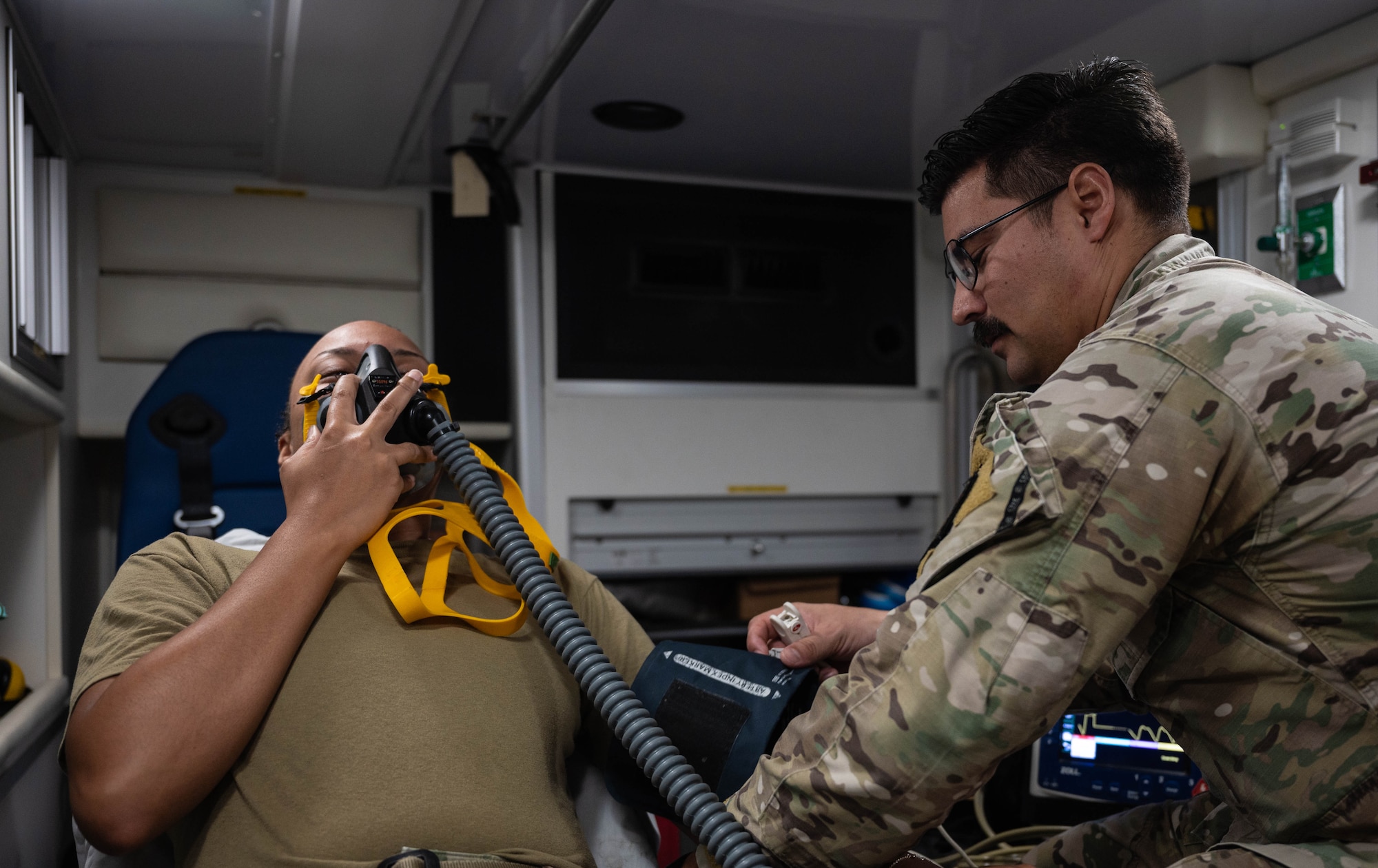 U.S. Air Force Tech. Sgt. Stephen Kreidler, right, 51st Operational Medical Readiness Squadron independent duty medical technician, checks vital signs on a patient at Osan Air Base, Republic of Korea, Aug. 13, 2024. Kreidler serves as the flight chief for inflight and ground emergency response, overseeing critical responsibilities in managing and coordinating emergency operations. Kreidler earned the title of Mustang of the Week for his dedication to the 51st OMRS mission.  (U.S. Air Force photo by Staff Sgt. Christopher Tam)