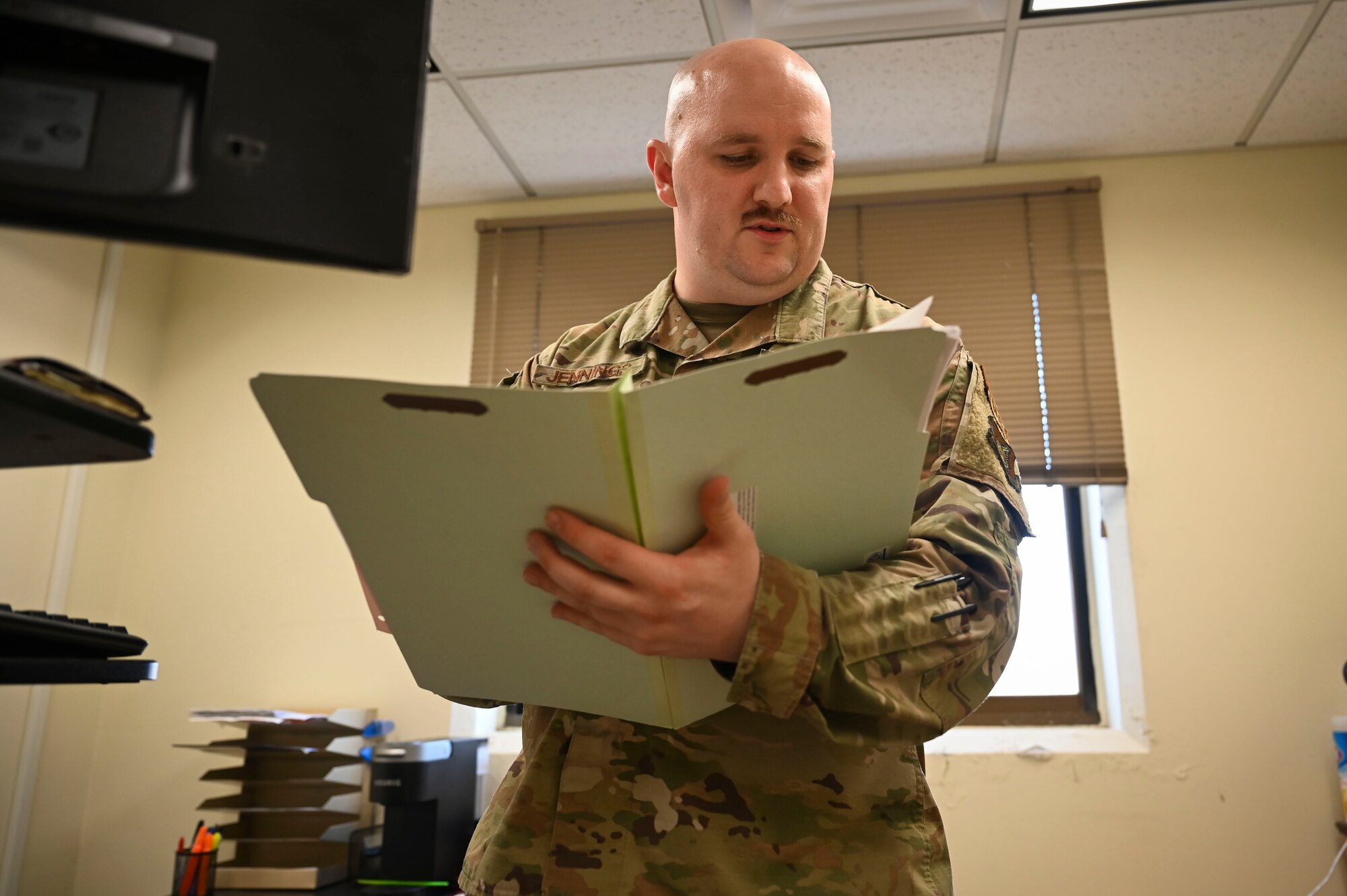 U.S. Air Force Tech. Sgt. Aaron Jennings, 8th Operations Support Squadron noncommissioned officer in charge of current operations flight, reviews jump and flight record folders.