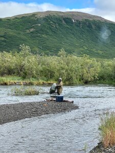 Chief Warrant Officer 3 Nick Lime, an aviation maintenance technician and crew chief assigned to Delta Company, 2-211th General Support Aviation Battalion, inspects a missing rafter’s pack raft from the Goodnews River, Aug. 12, 2024. Alaska Army National Guard aviators with Alpha Company, 1-168th General Support Aviation Battalion, operating a UH-60L Black Hawk helicopter out of Bethel, Alaska, helped rescue an overdue rafter near Goodnews Lake.