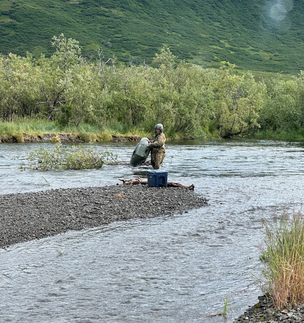 Chief Warrant Officer 3 Nick Lime, an aviation maintenance technician and crew chief assigned to Delta Company, 2-211th General Support Aviation Battalion, inspects a missing rafter’s pack raft from the Goodnews River Aug. 12, 2024. Alaska Army National Guard aviators with Alpha Company, 1-168th General Support Aviation Battalion, operating a UH-60L Black Hawk helicopter out of Bethel, Alaska, helped rescue an overdue rafter near Goodnews Lake.