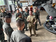 Chief Warrant Officer 2 Chris Cuddington, pilot, 1st Battalion, 168th General Support Aviation, talks with his counterparts from the 9th Aviation Battalion during an aviation subject matter expert exchange in Lop Buri, Thailand, July 31, 2024.