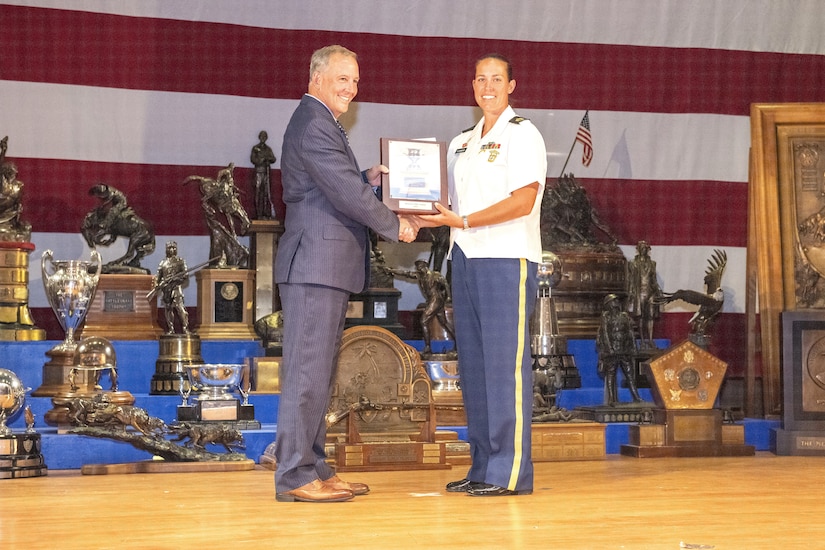 Sgt. 1st Class Amanda Elsenboss, right, of the Pennsylvania National Guard Joint Force Headquarters receives the Women’s Rifle Trophy following the National Matches held at Camp Perry, Ohio, Aug. 2, 2024. (U.S. Air National Guard photo by Senior Master Sgt. Shawn Monk)