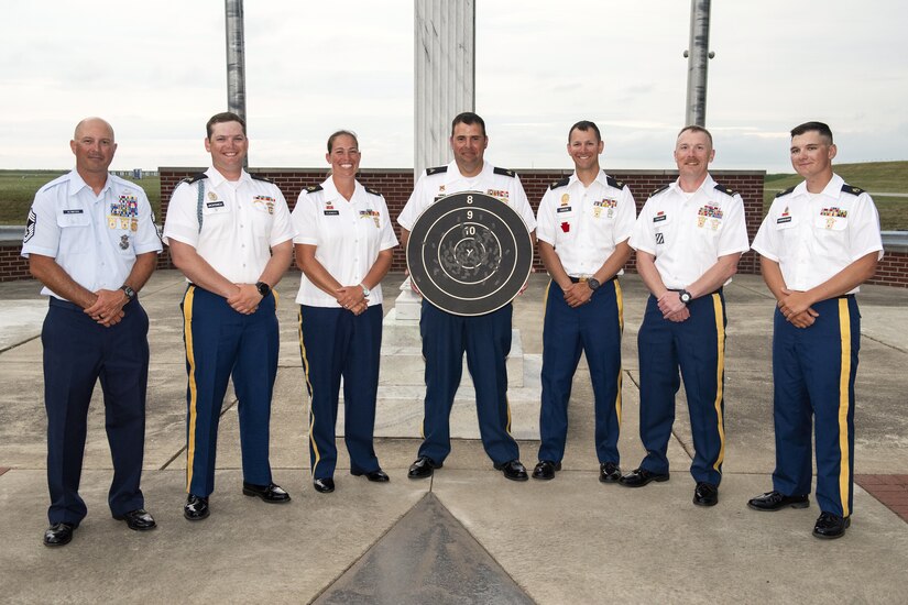 The All National Guard Rifle Team poses with the target they struck from 600 yards after winning the National Trophy also known as the Dogs of War Trophy, and the Hilton Trophy during the National Matches at Camp Perry, Ohio, Aug. 2, 2024. This is the third time that the National Guard won the National Trophy since its inception in 1903, the last time being in 1986 and 1977. (U.S. Air National Guard photo by Senior Master Sgt. Shawn Monk)