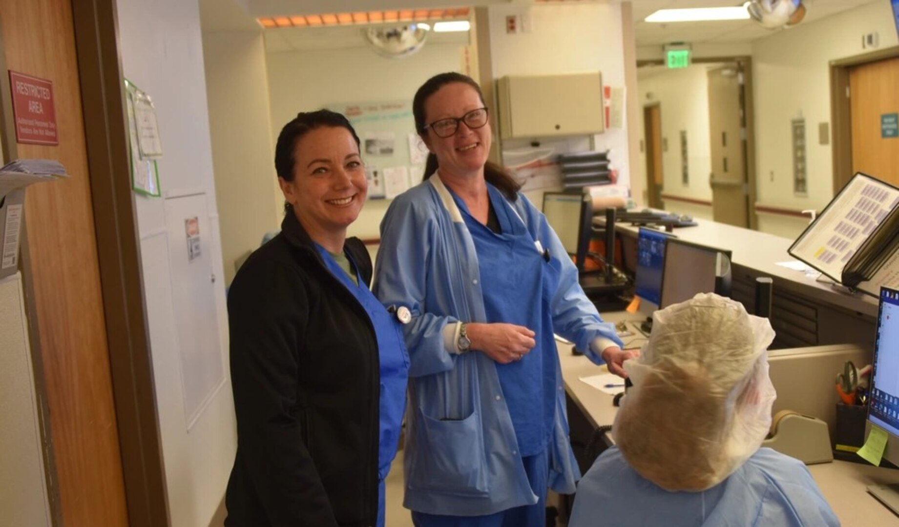 Lt. Col. Kimberly Dilger, Deputy Commander for Quality and Safety and Perioperative Nursing chief at Womack Army Medical Center and Sgt.1st Class Justyna Robinson, non-commissioned officer in charge of the operating room, pause for a quick picture during a brief discussion.