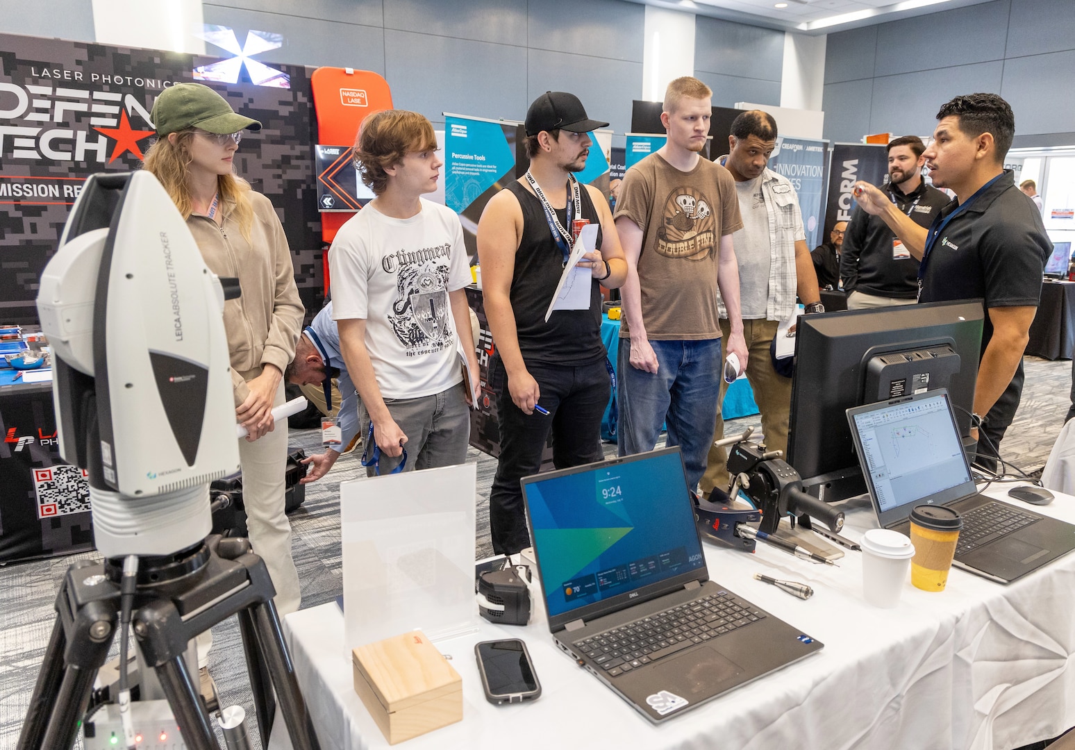 Employees with Shop 67, Electronics, watch as Hexagon representative Justin Lopez demonstrates a new laser scanner July 31, 2024, during the annual Puget Sound Naval Shipyard & Intermediate Maintenance Facility Technology Showcase at the Kitsap Conference Center in downtown Bremerton, Washington. (U.S Navy Photo by Wendy Hallmark)