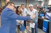 Kayla Guevarra and Giang Phang, both insulator helpers, Shop 57, Pipe Insulators, watch a demonstration with ARSME Technology representative Joseph Wysocki July 31, 2024, during the annual PSNS & IMF Technology Showcase at the Kitsap Conference Center in downtown Bremerton, Washington. (U.S Navy Photo by Wendy Hallmark)