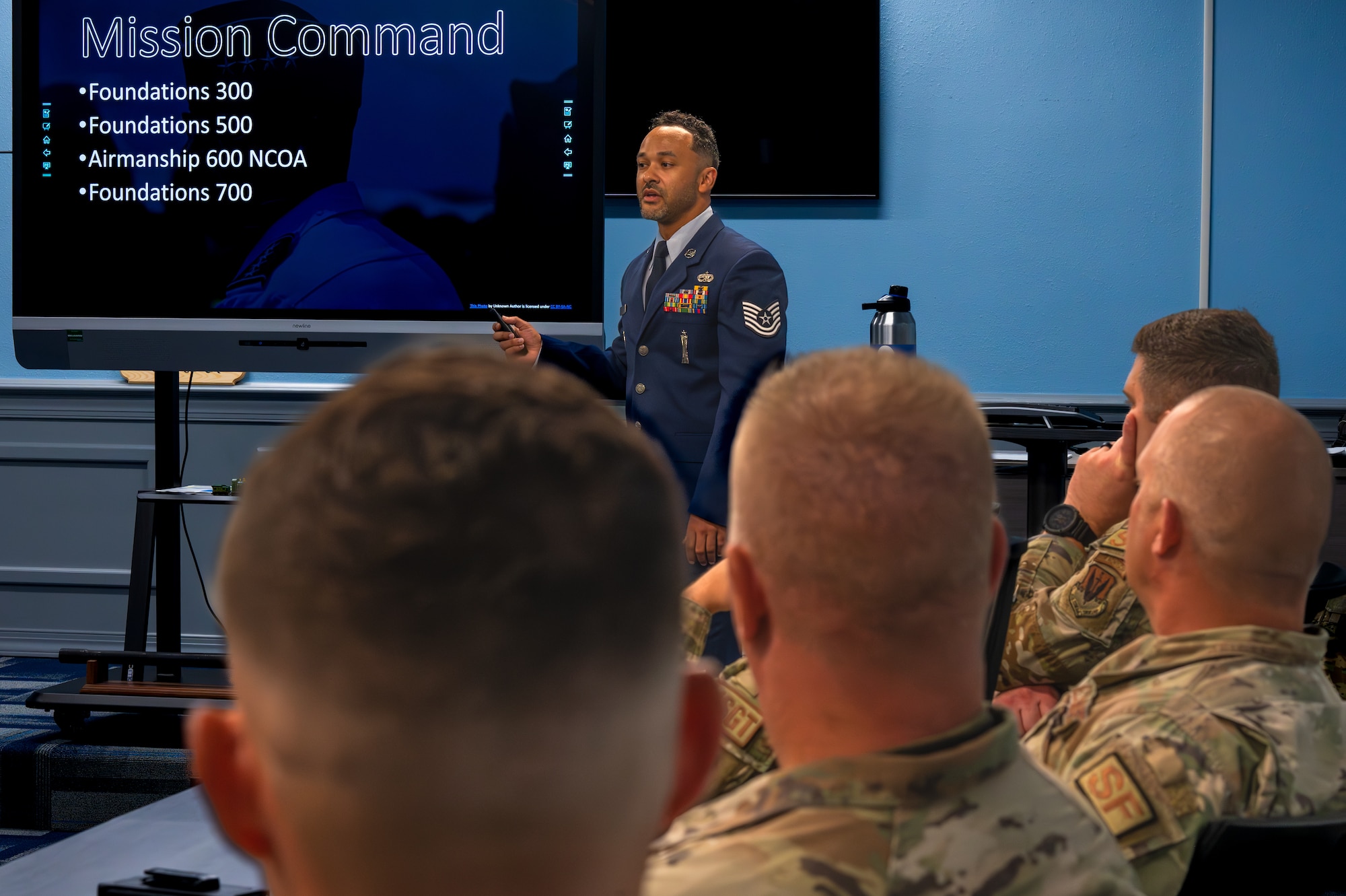 NCO gives brief to senior enlisted leaders and local civic leaders on base