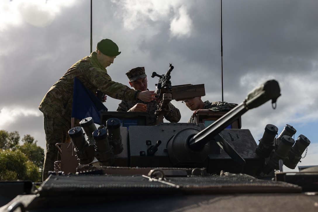 U.S. Marines with Alpha Company, 1st Light Armored Reconnaissance Battalion, 1st Marine Division, tour an Australian Army LAV-25 Light Armored Vehicle with an Australian Soldier with 1st Armoured Regiment, 9th Brigade, as part of a meet and greet during Rapid Deployment Exercise at Royal Australian Air Force Base Edinburgh, Australia, July 15, 2024. REDEX is a 1st MARDIV training exercise, with this year’s iteration planned in conjunction with Marine Rotational Force – Darwin 24.3, to rehearse the ability to rapidly deploy capabilities from Marine Corps Base Camp Pendleton, California, U.S., to Australia. 1st LAR tested the logistical efficiency and unit readiness required to rapidly deploy a heavy equipment unit within the U.S. Indo-Pacific Command theater by strategic lift and rail to participate in Exercise Predator’s Run 24. (U.S. Marine Corps photo by Cpl. Earik Barton)