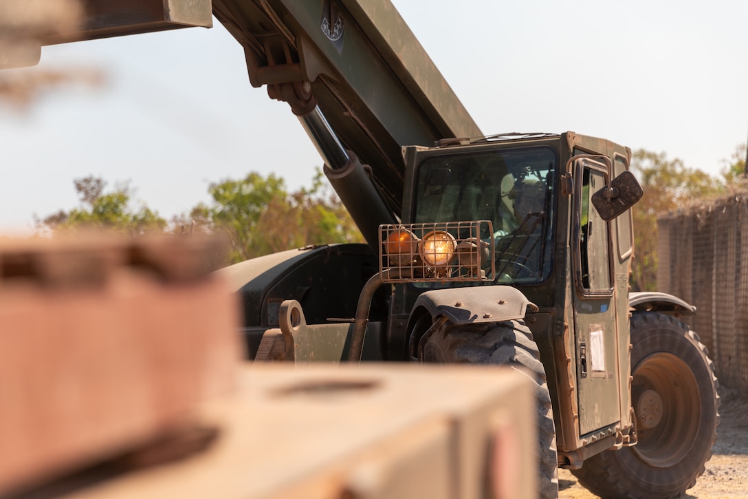 U.S. Marine Corps Lance Cpl. Anthony Rosales, a heavy equipment operator with Combat Logistics Battalion 5 (Reinforced), Marine Rotational Force – Darwin 24.3, operates a Tractor, Rubber-Tired, Articulating Steering, Multi-Purpose forklift during Exercise Predator’s Run 24 at Mount Bundey Training Area, NT, Australia, July 20, 2024. Exercise Predator’s Run 24 is a littoral-focused, multilateral training exercise led by the Australian’s Army 1st Brigade, involving the Australian Defence Force, the United Kingdom Commando Force, the Republic of the Philippines Army, the U.S. Marine Corps and the U.S. Navy. MRF-D 24.3’s Logistics Combat Element, CLB-5 (Rein.), provided comprehensive combat service support, logistics support, and enhanced health service support in a disaggregated environment. Rosales is a native of Nevada. (U.S. Marine Corps photo by Cpl. Migel A. Reynosa)