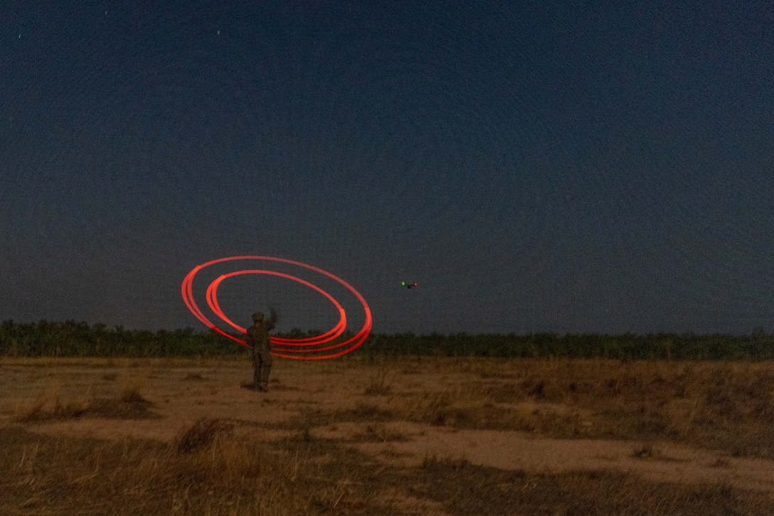 U.S. Marine Corps Cpl. Alex Brinkley, a point man with the Surveillance and Target Acquisition platoon, Weapons Company, 2nd Battalion, 5th Marine Regiment (Reinforced), Marine Rotational Force – Darwin 24.3, provides initial terminal guidance marks by buzz saw for MV-22B Osprey pilots with Marine Medium Tiltrotor Squadron 268 (Reinforced), MRF-D 24.3, to land, during Exercise Predator’s Run 24 at Mount Bundey Training Area, NT, Australia, July 22, 2024. Exercise Predator’s Run 24 is a littoral-focused, multilateral training exercise led by the Australian Army’s 1st Brigade. Exercise Predator’s Run 24 provides MRF-D 24.3 the opportunity to conduct training missions as a Marine Air-Ground Task Force, while integrating command and control, aviation, logistics, ground, off-continent, and allied capabilities, increasing warfighting readiness and better preparing the MAGTF to respond to crises or contingencies, contributing to security and stability in the Indo-Pacific region. Brinkley is a native of California. (U.S. Marine Corps photo by Gunnery Sgt. Kassie McDole)