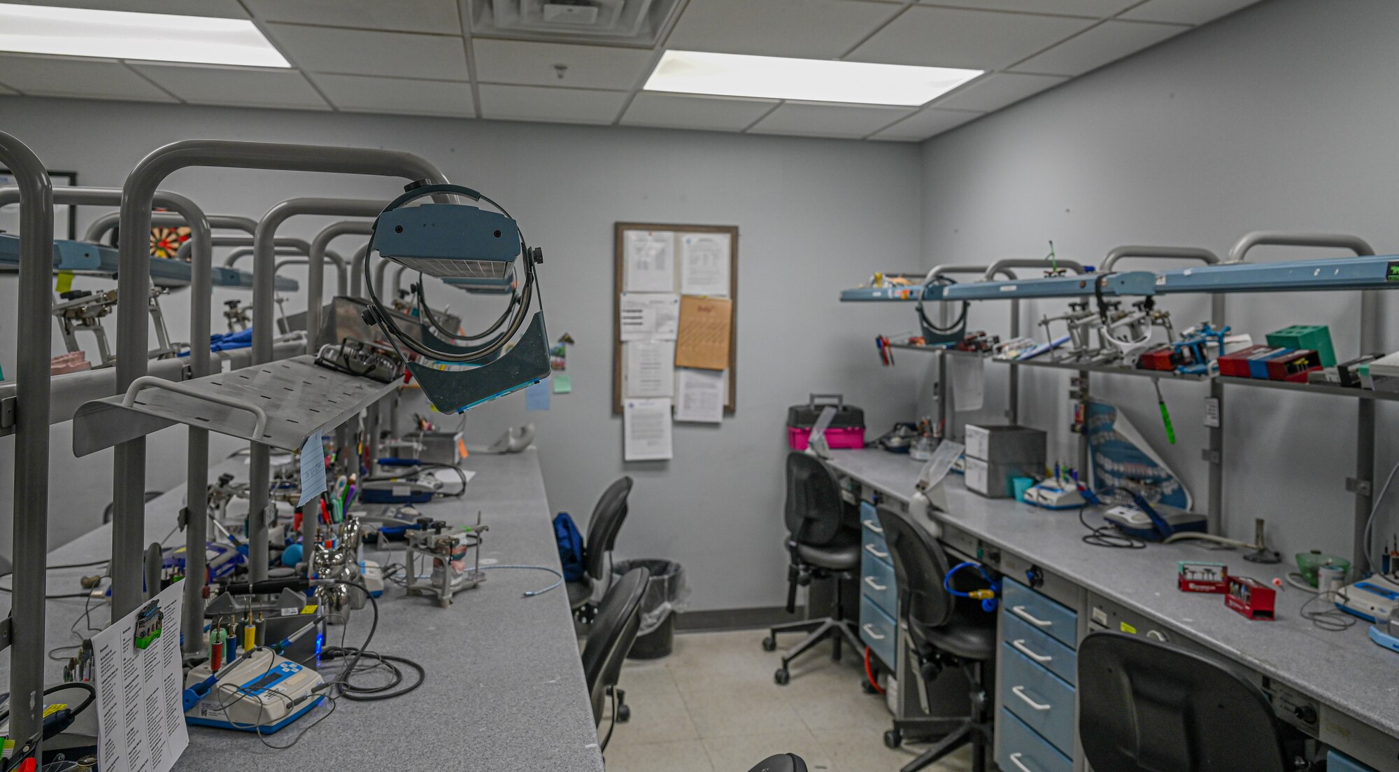 Photo of the inside of the dental lab. There are chairs, tables and lots of different pieces of equipment photo'd.