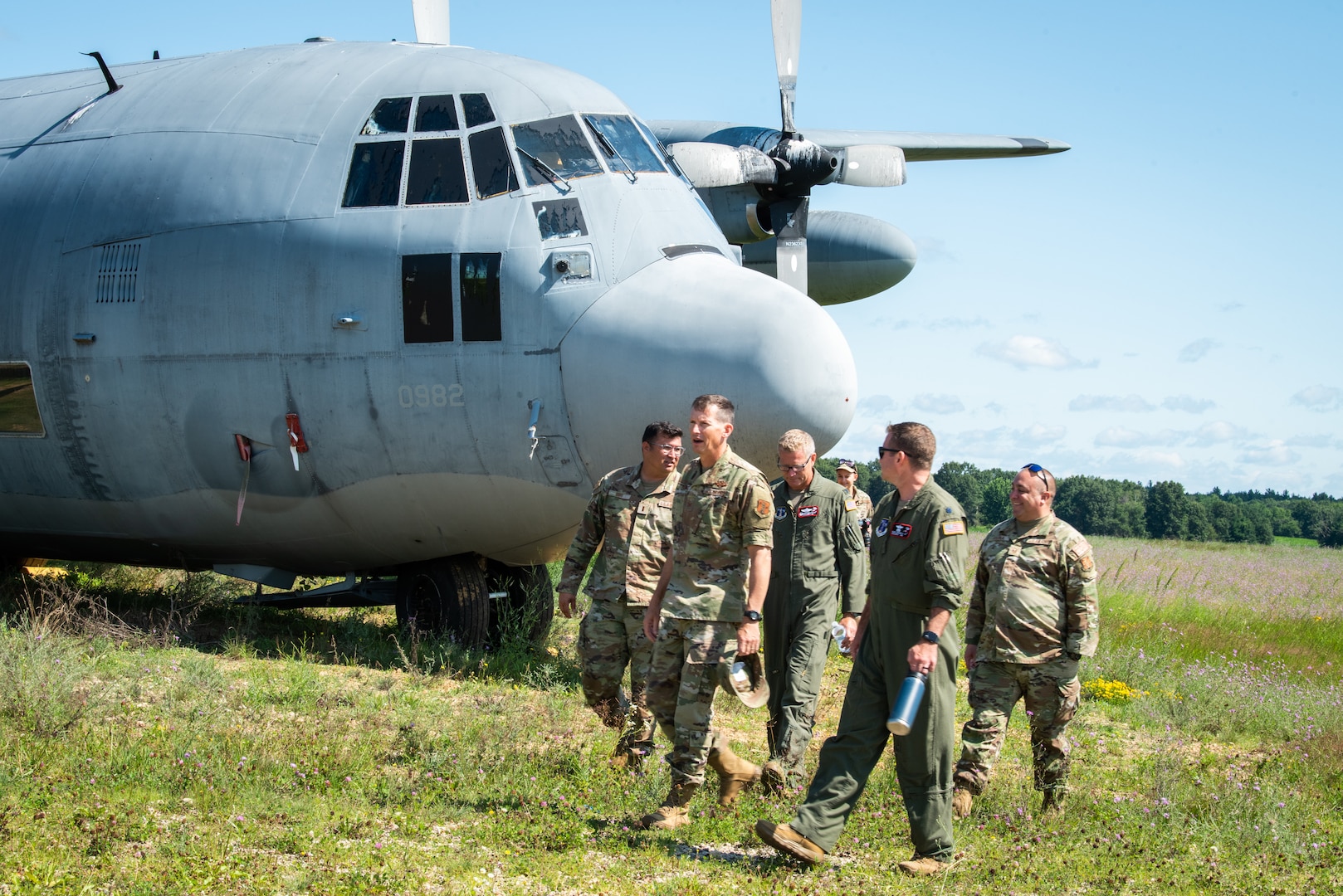 U.S. Air Force Col. Charles C. Merkel, 128th Air Refueling Wing commander, walks alongside 128th ARW leadership after observing non-operational aircraft used for aircraft recovery training at Volk Field Air National Guard base, Camp Douglas, Wisconsin, July 17, 2024. As part of the agile combat employment (ACE) training, Airmen were trained in different areas of their job operations to ensure multi-capability, interoperability, and efficiency during deployment and wartime situations. (U.S. Air National Guard photo by Airman 1st Class Cynthia Yang)