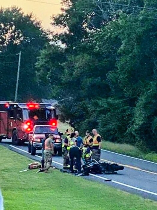 Emergency personnel and Staff Sgt. Erik Hill, 314th Aircraft Maintenance Squadron crew chief air propulsion maintenance, on the scene of a vehicle accident on State Highway 321, Cabot, Arkansas, July 24, 2024. Unprompted, Hill assisted in the aftermath of a critical collision on his way home from work.