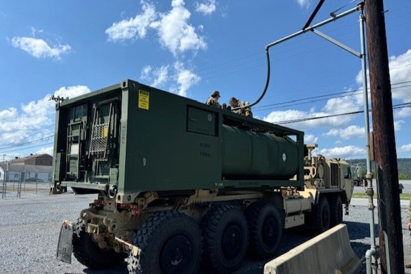 U.S. Soldiers with the 628th Aviation Support Battalion, 28th Expeditionary Combat Aviation Brigade, 28th Infantry Division fill water in an M105 Load Handling System Compatible Water Tank Rack, also known as a HIPPO bulk water distribution system, at Fort Indiantown Gap, Pennsylvania, Aug. 10, 2024. Their mission was to provide potable water to Penn State Health Holy Spirit Medical Center at Camp Hill after an emergency water advisory affected nearly 42000 customers in that part of the commonwealth. These Soldiers responded to a call from the Pennsylvania Emergency Management Agency for the Pennsylvania National Guard to assist. (Courtesy Photo)