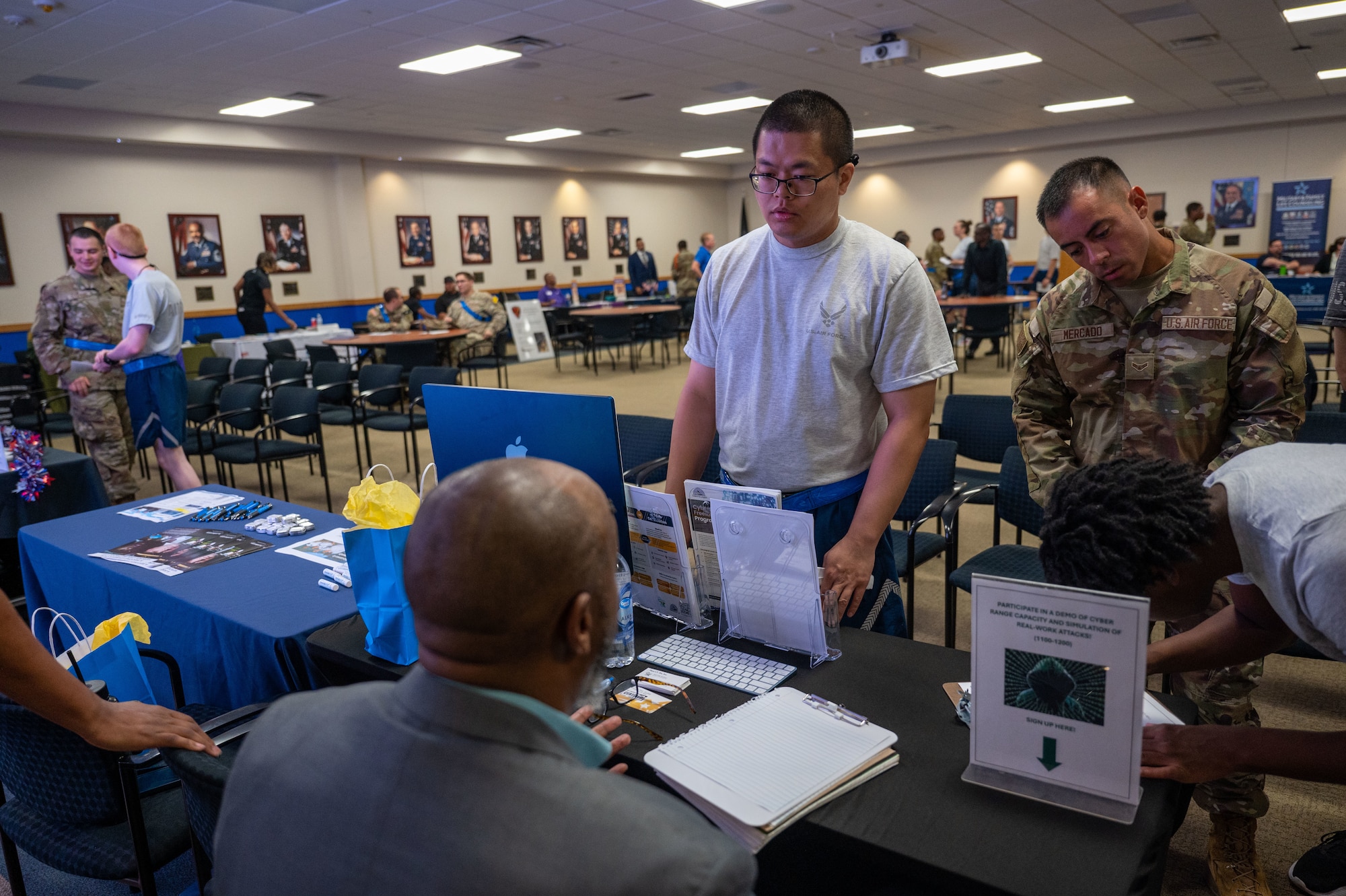 The 737th Training Group trainees (right) interact with representatives at the DRIVE (Develop, Redistribute, Improve, Vault, Expose) Joint Forces Employment Fast Track event on June 28, 2024, at the Pfingston Reception Center on Joint Base San Antonio-Lackland.