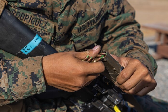 A U.S. Marine Corps recruit with Kilo Company, 3rd Recruit Training Battalion, loads a magazine prior to conducting the table one course of fire at Marine Corps Base Camp Pendleton, California, Aug. 6, 2024. Table one covered the basic fundamentals of marksmanship and rifle safety in all shooting positions: standing, sitting, kneeling, and the prone. (U.S. Marine Corps photo by Lance Cpl. Jacob B. Hutchinson)