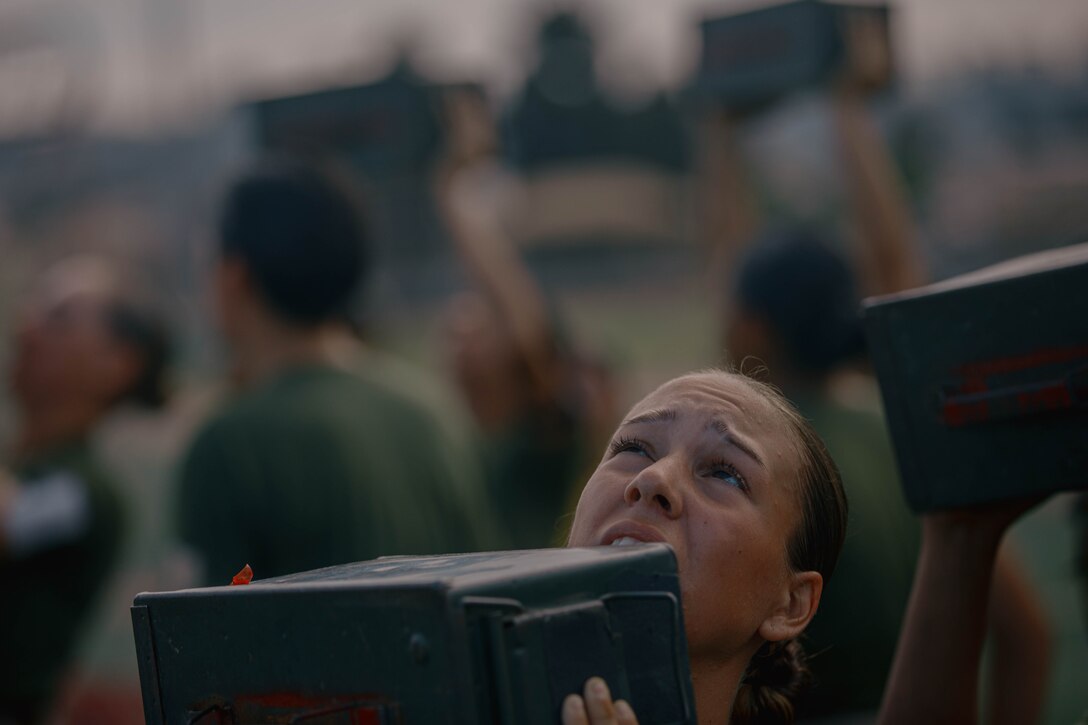 U.S. Marine Corps Recruit Enae Veldares, a recruit with Fox Company, 2nd Recruit Training Battalion, conducts the ammunition can lift portion of a combat fitness test at Marine Corps Recruit Depot Diego, California, Aug. 1, 2024. The CFT is an annual fitness test that is required of all Marines to pass and maintain consisting of an 880-yard sprint, ammunition can lifts, and a maneuver under fire drill. Veldares was recruited out of Recruiting Station Amarillo, Texas.(U.S. Marine Corps photo by Cpl. Elliott A. Flood-Johnson)