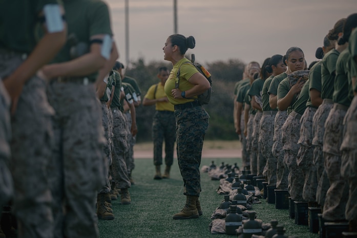 A U.S. Marine Corps drill instructor with Fox Company, 2nd Recruit Training Battalion, directs recruits during a combat fitness test at Marine Corps Recruit Depot San Diego, California, Aug. 1, 2024. The CFT is an annual fitness test that is required of all Marines to pass and maintain consisting of an 880-yard sprint, ammunition can lifts, and a maneuver under fire drill. (U.S. Marine Corps photo by Cpl. Elliott A. Flood-Johnson)